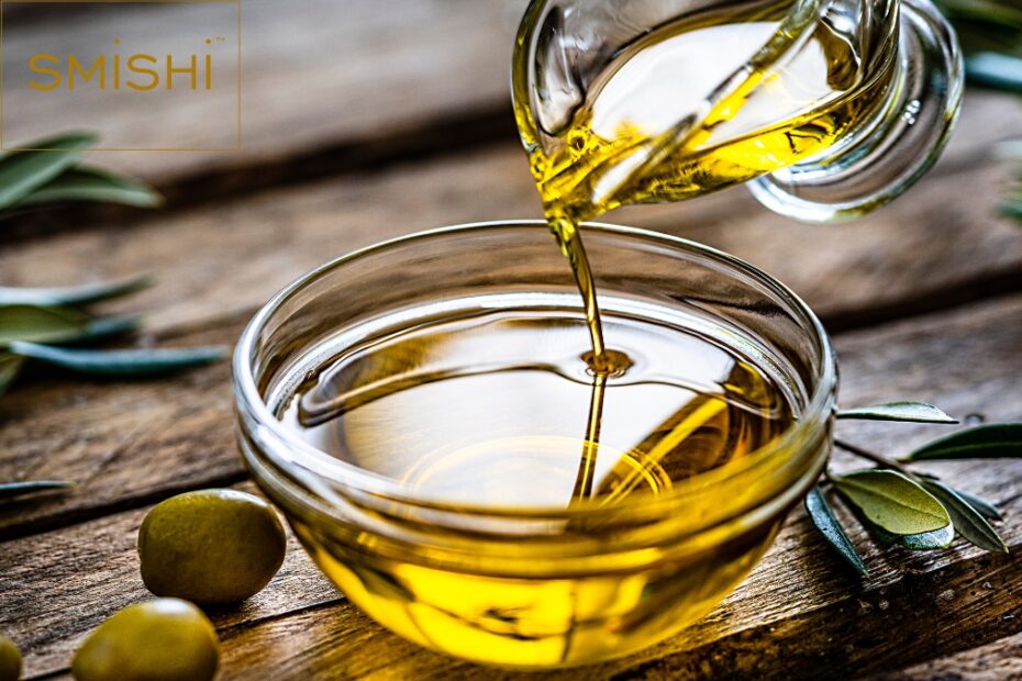 Extra virgin olive oil being poured from a sleek bottle into a bowl, showcasing its rich golden hue and premium quality.